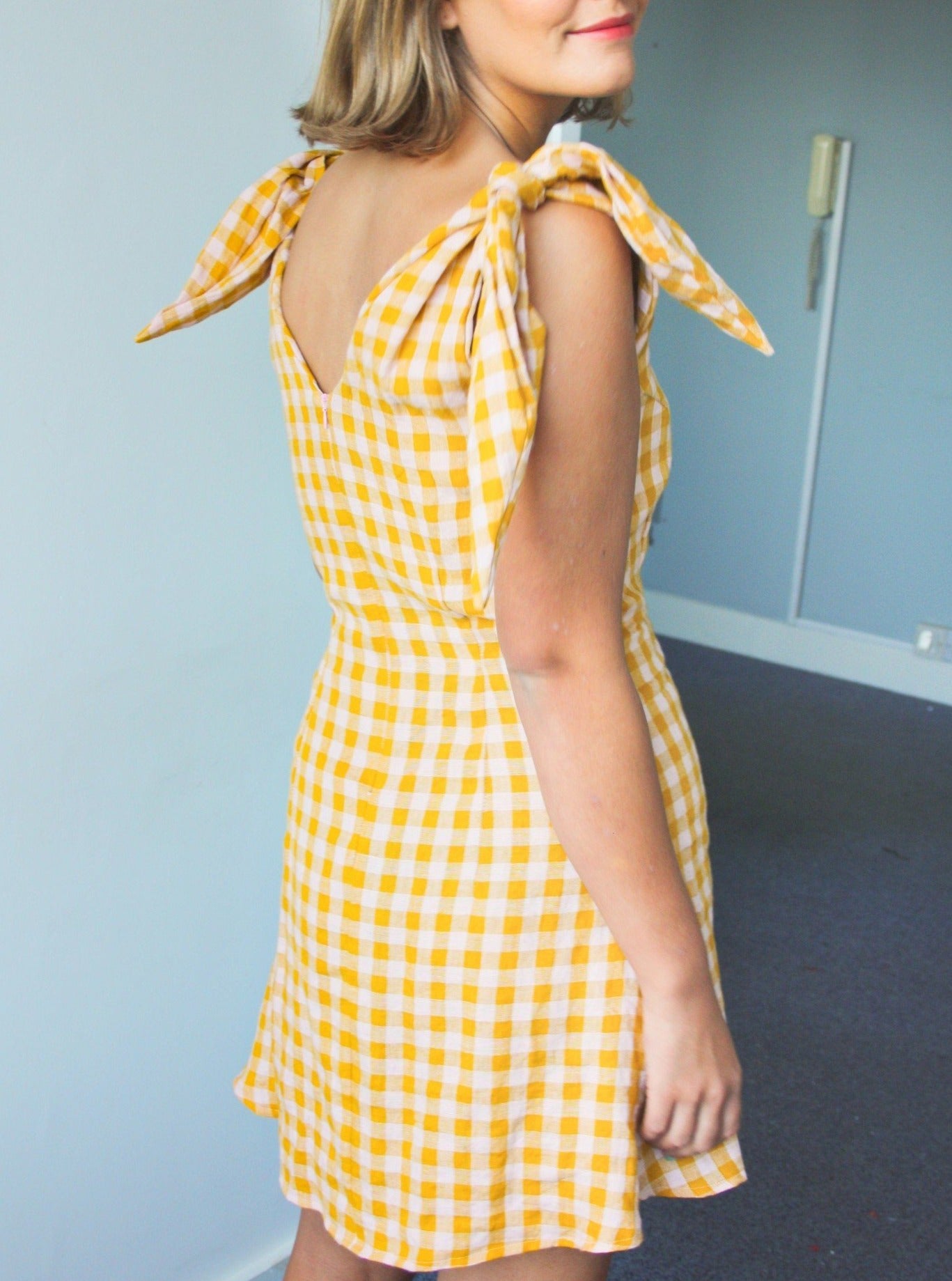 Ethically made sustainable linen gingham check pink and yellow mini dress